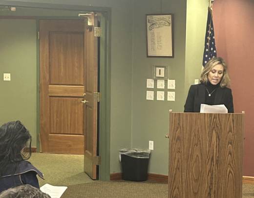 Jill Sylvester speaking at a podium at the John Curtis Library